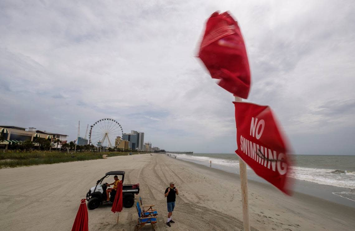 No swimming flags fly over a lifeguard stand in downtown Myrtle Beach on Monday. Tropical Storm Isaias is moving up the east coast and is expected to make landfall near Myrtle Beach on Monday night. August 3, 2020.