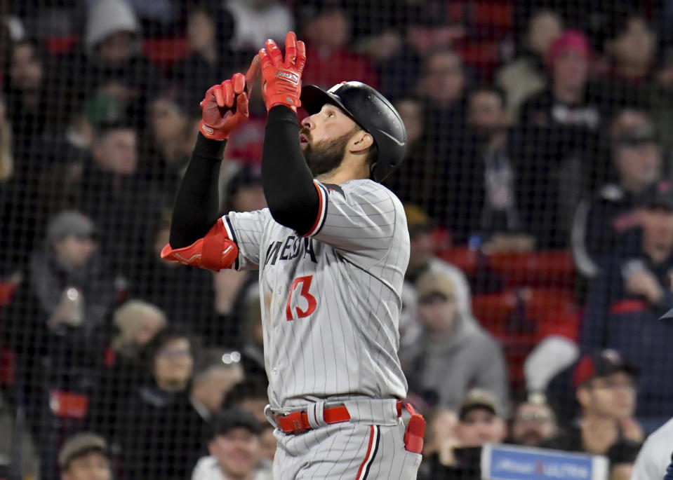 Minnesota Twins' Joey Gallo signals skyward after hitting a three-run home run during the third inning of the baseball game against the Boston Red Sox at Fenway Park, Wednesday, April 19, 2023, in Boston. (AP Photo/Mark Stockwell)