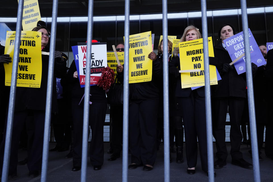 Flight attendants protest at O'Hare International Airport in Chicago, Tuesday, Feb. 13, 2024. Three separate unions representing flight attendants at major U.S. airlines are picketing and holding rallies at 30 airports on Tuesday as they push for new contracts and higher wages. (AP Photo/Nam Y. Huh)