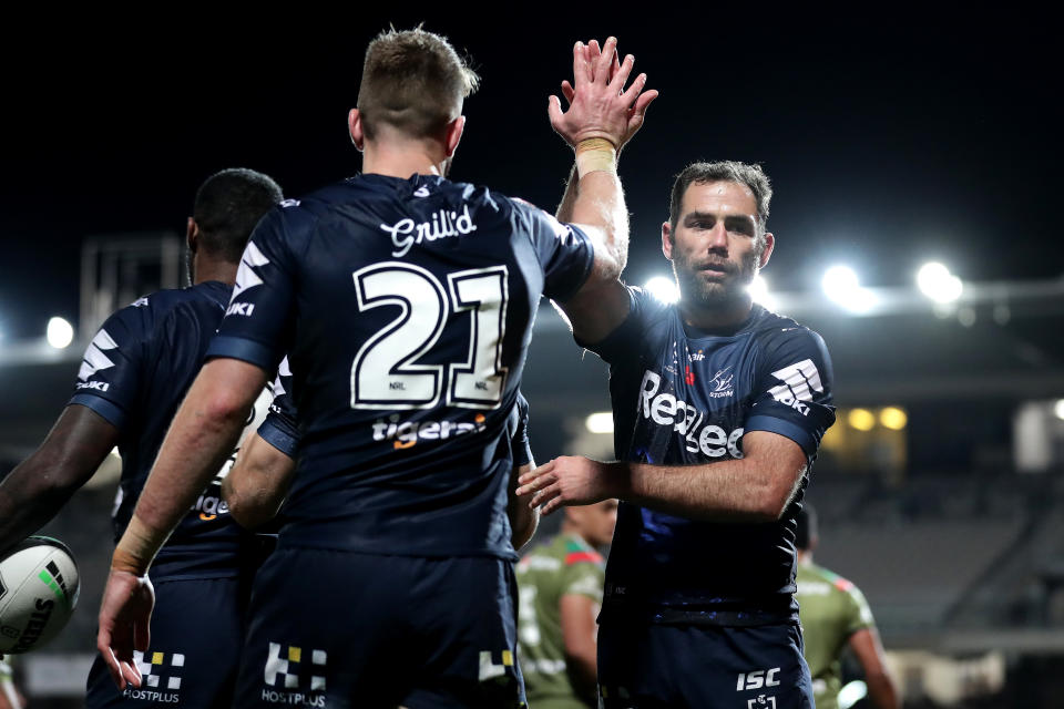 Cameron Smith and Paul Momirovski high-five and celebrate.