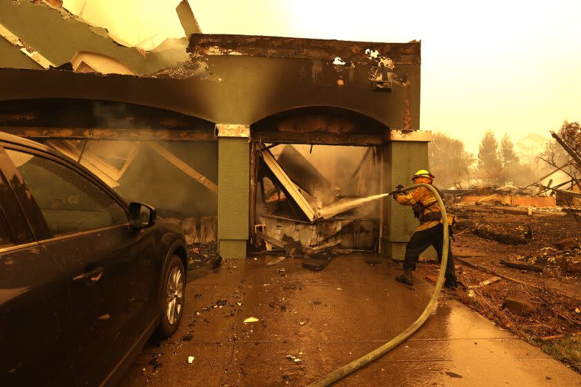 SANTA ROSA, CALIFORNIA - SEPTEMBER 28: A San Bruno firefighter puts out hotspots in a home that was destroyed by the Glass Incident on September 28, 2020 in Santa Rosa, California. The fast-moving Glass Incident, originally called the Glass Fire, has burned over 11,000 acres in Sonoma and Napa counties. The fire is zero percent contained. Much of Northern California is under a red flag warning for high fire danger through Monday evening. (Photo by Justin Sullivan/Getty Images)