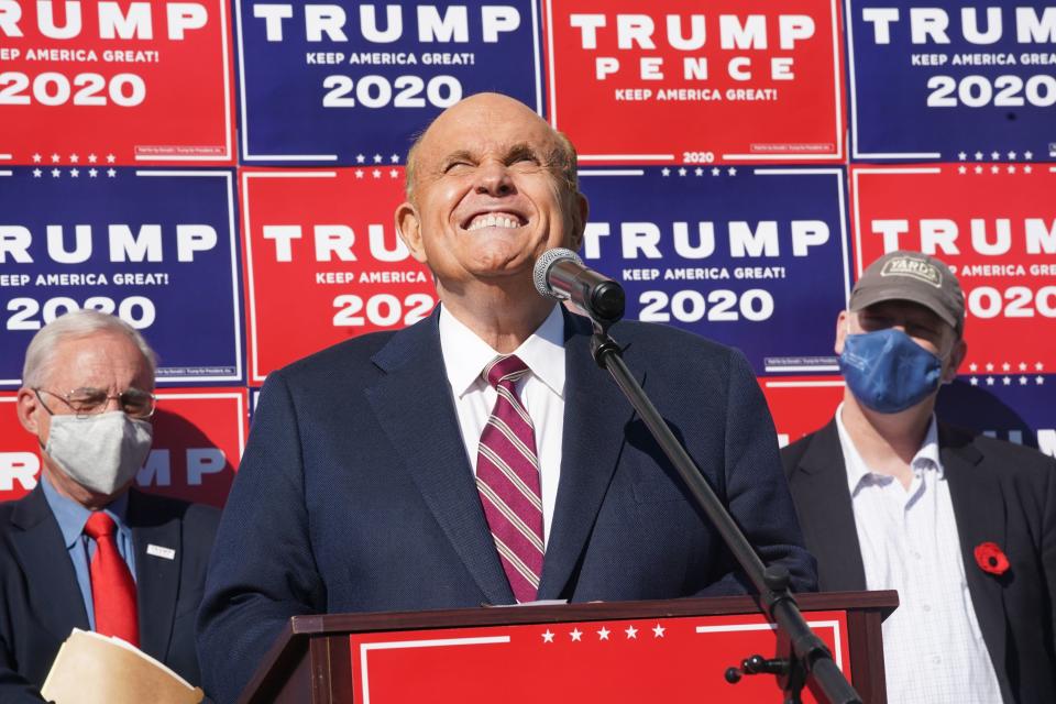 <p>Attorney for Donald Trump, Rudy Giuliani, speaks at a news conference in the parking lot of a landscaping company on November 7, 2020 in Philadelphia</p> (Photo by BRYAN R. SMITH/AFP via Getty Images)