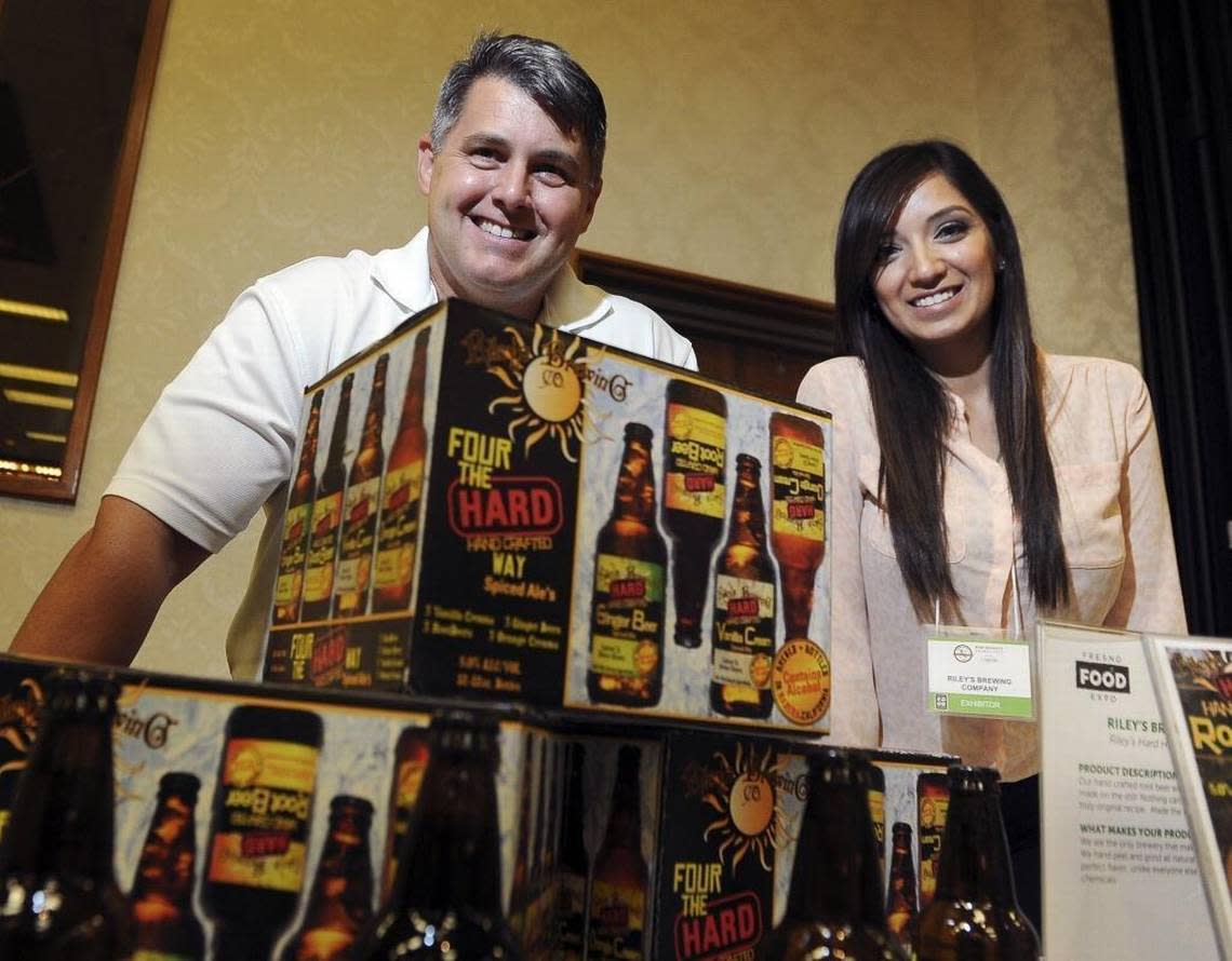 Riley’s Brewing Company president Dan Riley, left , with corporate sales manager Angelina Zambrano, right, show off the Madera company’s beer offerings, including its new vanilla creme.