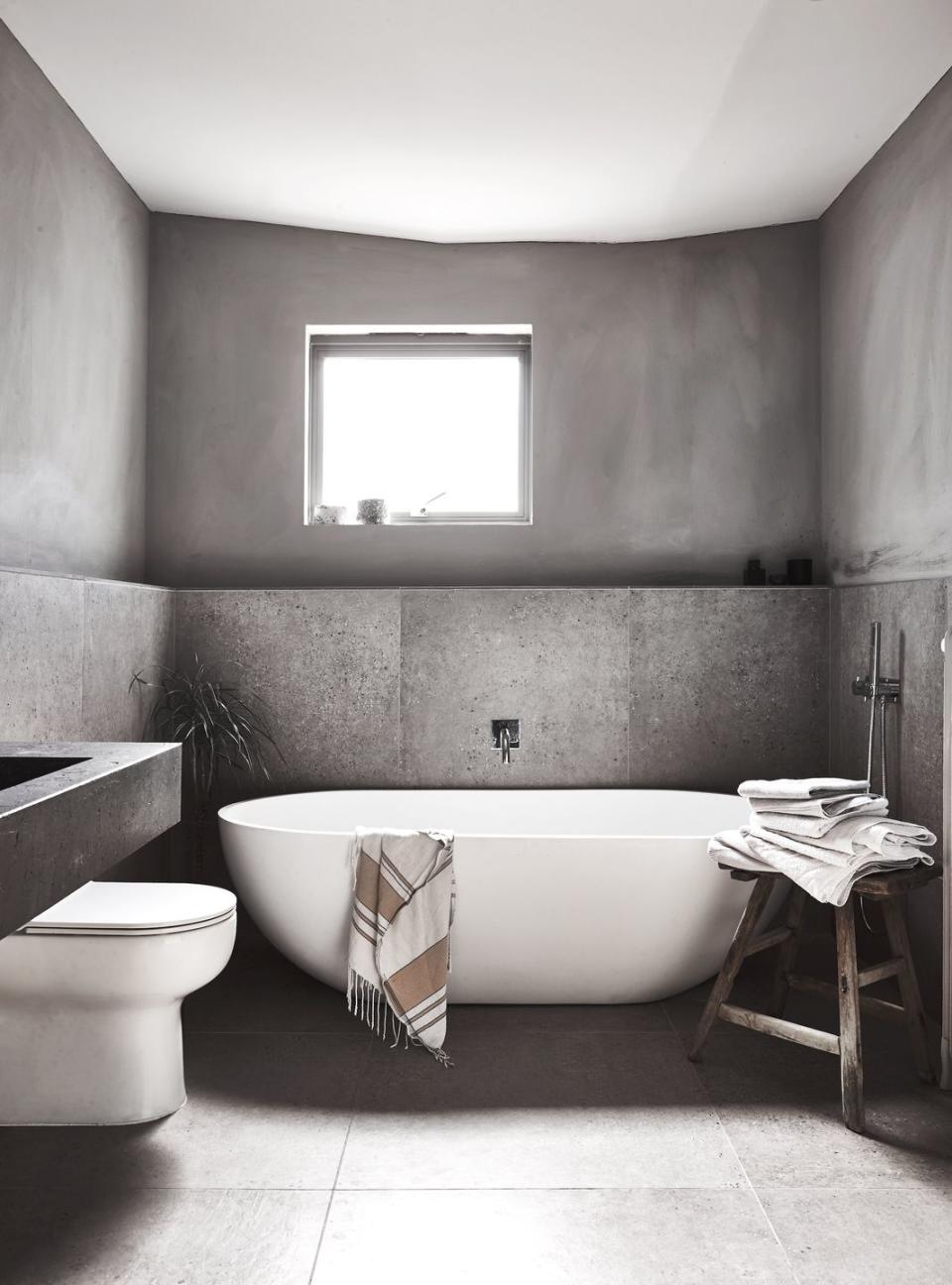 a bathroom with a tub and toilet