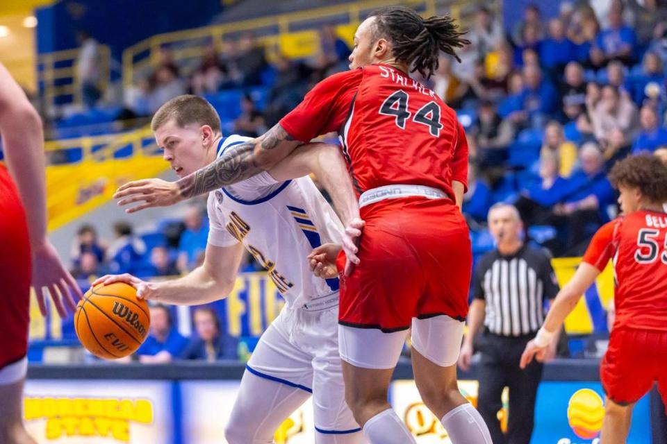 Morehead State guard Riley Minix (22) drives the ball as Southeast Missouri State guard Braxton Stacker (44) defends during a game at Johnson Arena in Morehead on Feb. 29. Minix is the 2024 Ohio Valley Conference Player of the Year. Ryan C. Hermens/rhermens@herald-leader.com