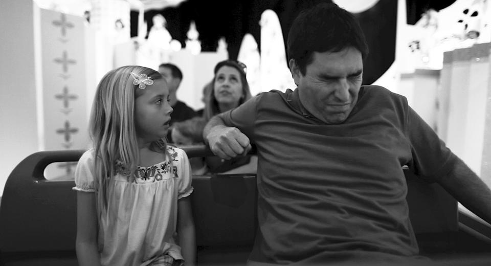 This undated photo released by Mankurt Media, LLC shows Roy Abramsohn as Jim freaking out during a ride in the amusement park on the last day of his family vacation in a scene from "Escape from Tomorrow," a feature film by writer/director Randy Moore. As an adult, and a filmmaker, Moore wanted to capture and question the allure of manufactured-fantasy theme parks. (AP Photo/Copyright Mankurt Media, LLC)