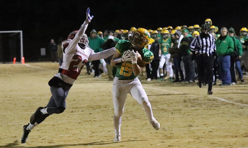 Eastern Alamance receiver Hunter Westbrooks, right, makes a grab as Jacksonville's Sevian Pickett defends.