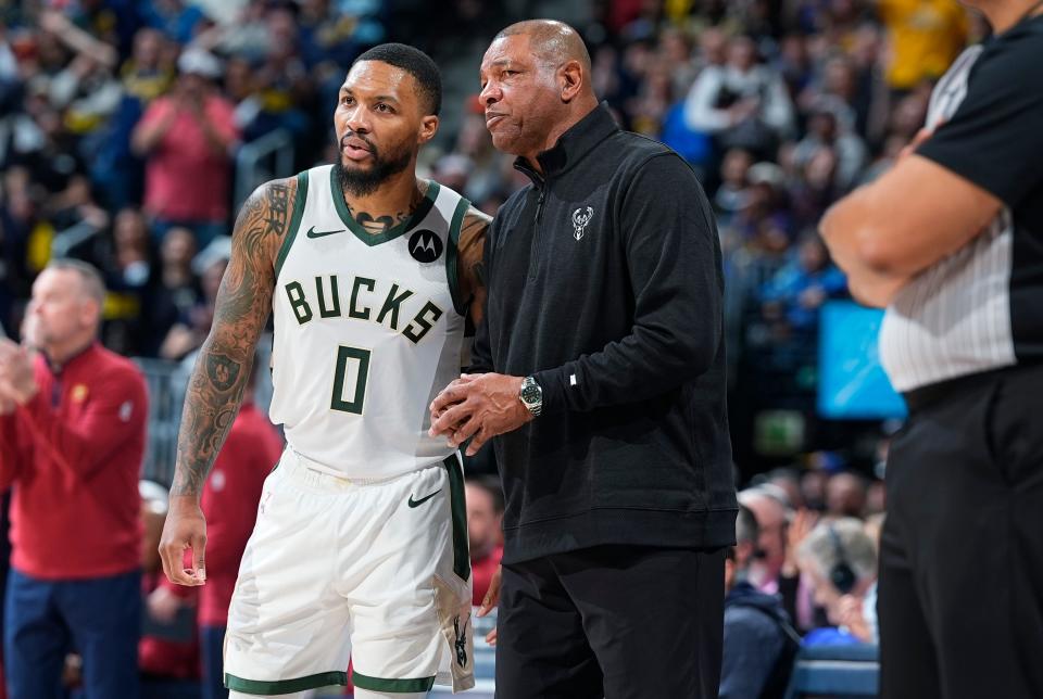 Milwaukee Bucks guard Damian Lillard (0) confers with Bucks head coach Doc Rivers late in the second half of an NBA basketball game against the Denver Nuggets on Jan. 29 in Denver.
