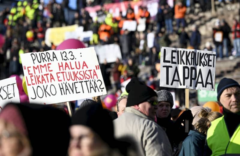 People take part in a demonstration organised by SAK and STTK against labour market reforms planned by the conservative government at the Senate Square. Vesa Moilanen/Lehtikuva/dpa