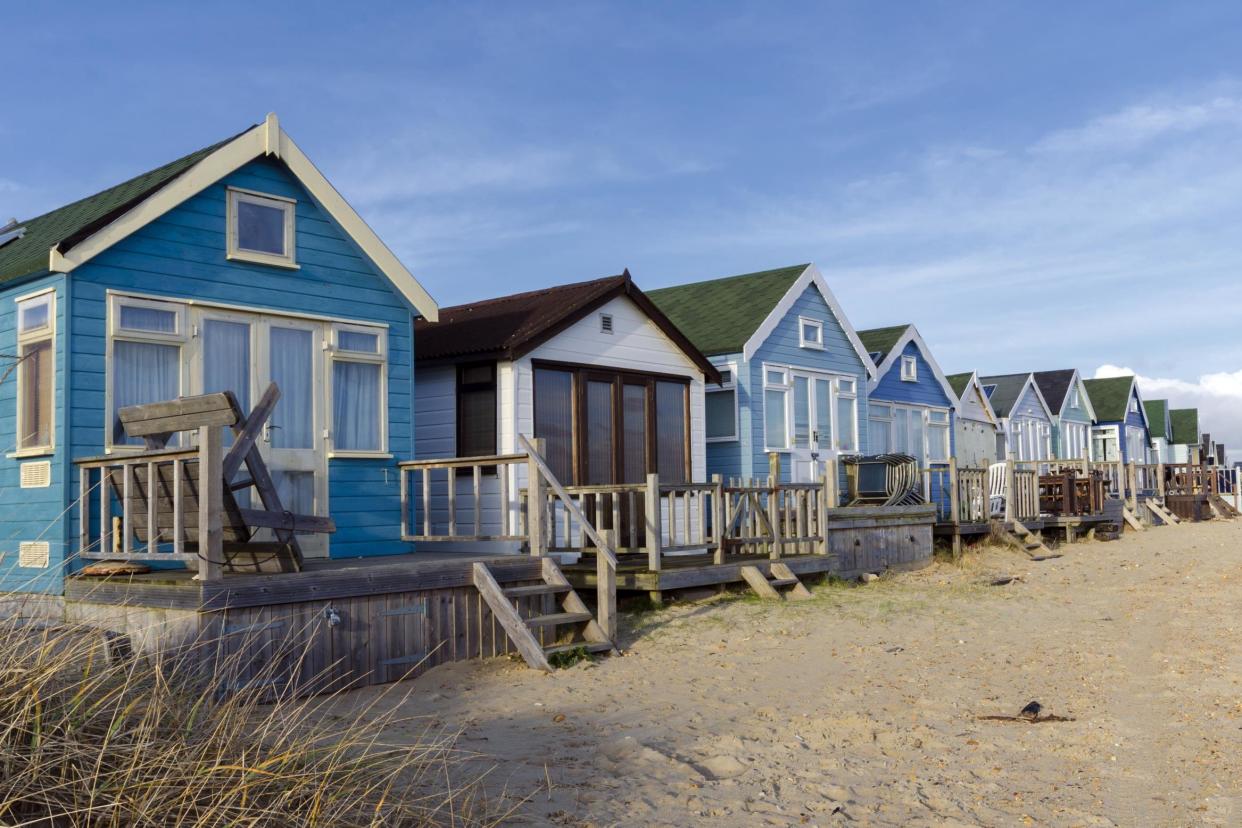 A selection of beach huts on the desirable Budeford spit: istock