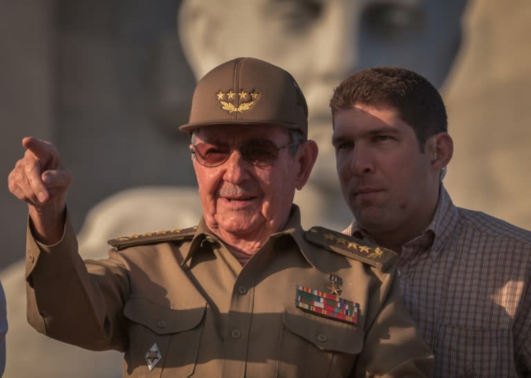 Cuban President Raul Castro, next to his grandson and bodyguard, attends the May Day parade in Havana on May 1, 2017