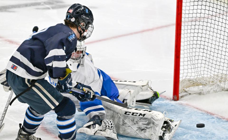 BOSTON 03/19/23  Colin McIver of Sandwich puts the puck past Norwell goalie Sean Donovan for the their first goal in the MIAA Division 4 final hockey