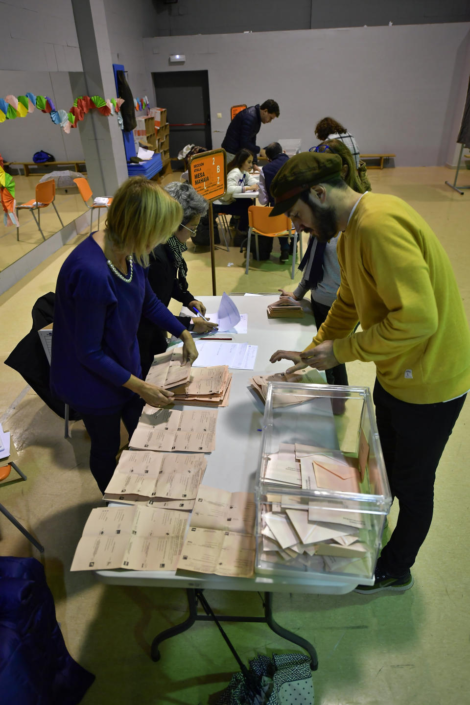 Election officials count votes at a polling station for the general election, in Pamplona, northern Spain, Sunday, Nov. 10, 2019. As Spaniards voted Sunday in the country’s fourth election in as many years, a leading leftist party pledged to help the incumbent Socialists in hopes of staving off a possible right-wing coalition government that could include a far-right party. (AP Photo/Alvaro Barrientos)