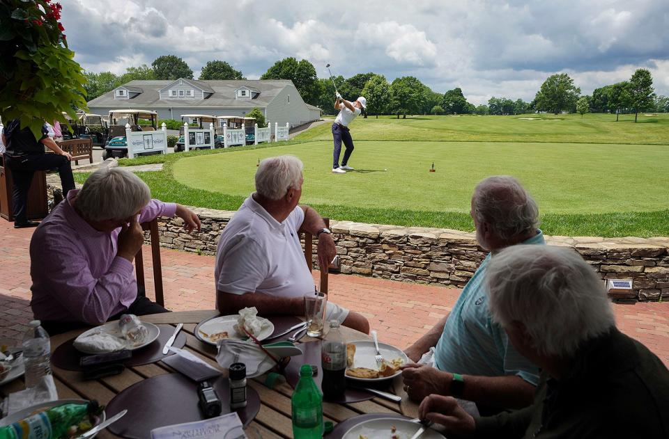 The lunch crowd watches Herman Sekne of Norway drive from the first tee during the first round of the Northeast Amateur on Wednesday at Wannamoisett Country Club in East Providence.