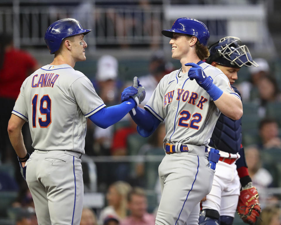 New York Mets' Brett Baty, right, is congratulated by Mark Canha for a two-run home run against the Atlanta Braves, in his first at-bat in the majors, during the second inning in a baseball game Wednesday, Aug. 17, 2022, in Atlanta. (Curtis Compton/Atlanta Journal-Constitution via AP)