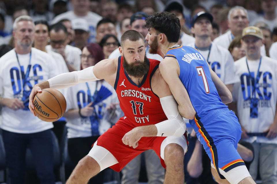 New Orleans Pelicans center Jonas Valanciunas (17) is defended by Oklahoma City Thunder forward Chet Holmgren (7) during the first half in Game 2 of an NBA basketball first-round playoff series Wednesday, April 24, 2024, in Oklahoma City. (AP Photo/Nate Billings)