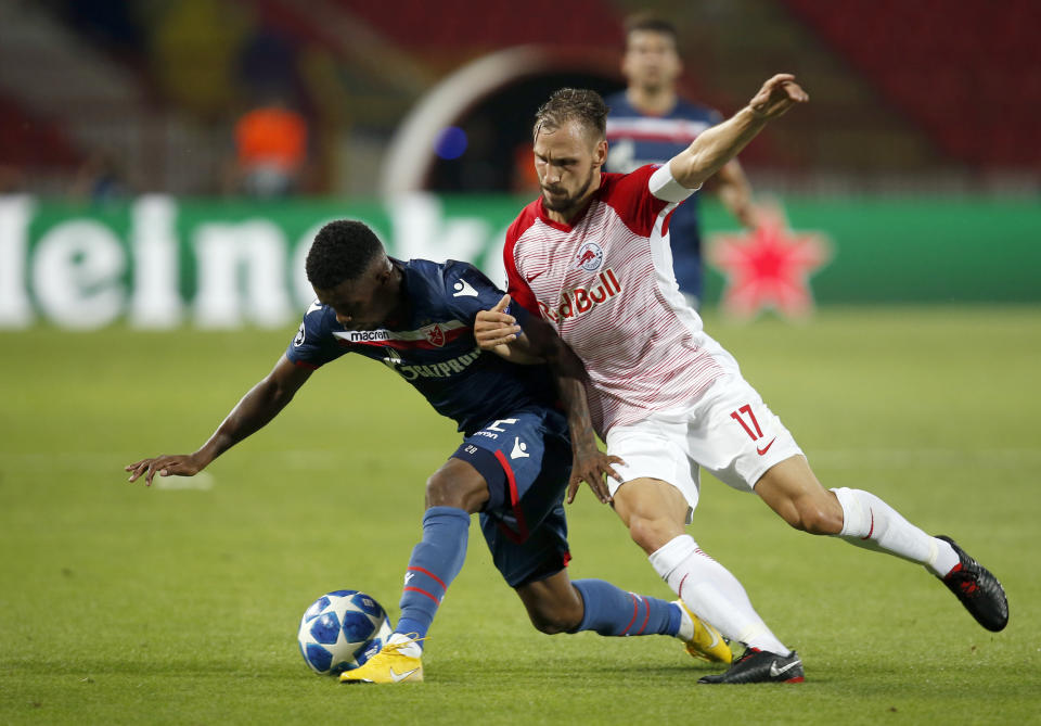 Red Star's Jonathan Cafu, left, duels for the ball with Salzburg's Andreas Ulmer during the Champions League qualifying play-off first leg soccer match between Red Star and Salzburg on the stadium Rajko Mitic in Belgrade, Serbia, Tuesday, Aug. 21, 2018. (AP Photo/Darko Vojinovic)
