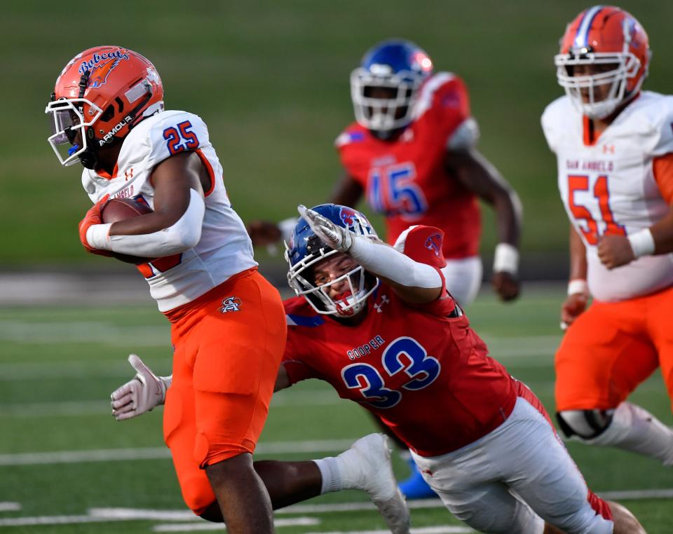 San Angelo Central running back Tyree Brawley is pursued by Cougars linebacker Johnathan Vanwinkle during the Sept. 9 game at Shotwell Stadium Sept. 9, 2022. Cooper won 41-38 in overtime.
