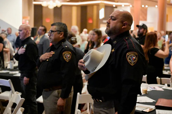 Zapata County, Texas, Sheriff Raymundo Del Bosque holds his hat over his heart during the national anthem during an event held by the Constitutional Sheriffs and Peace Officers Association in Las Vegas. 