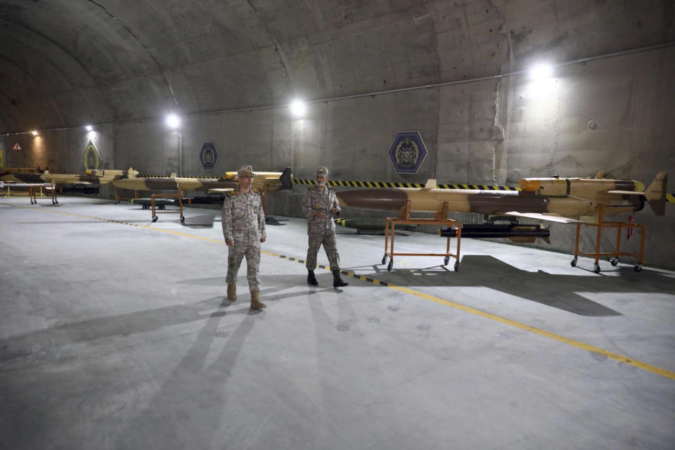 In this photo released on Saturday, May 28, 2022 by website of the Iranian Army, Chief of the General Staff of the Armed Forces Gen. Mohammad Hossein Bagheri, left, and Commander of the Army Gen. Abdolrahim Mousavi talk while visiting an underground drone base tunnel of the Army in the heart of the country's western Zagros Mountains. Iranian state television's report said Saturday, the tunnel was some 100 meters (330 feet) underground and was home to the Kaman-22 and Fotros drones, both capable of carrying cruise missiles. (Iranian Army via AP)