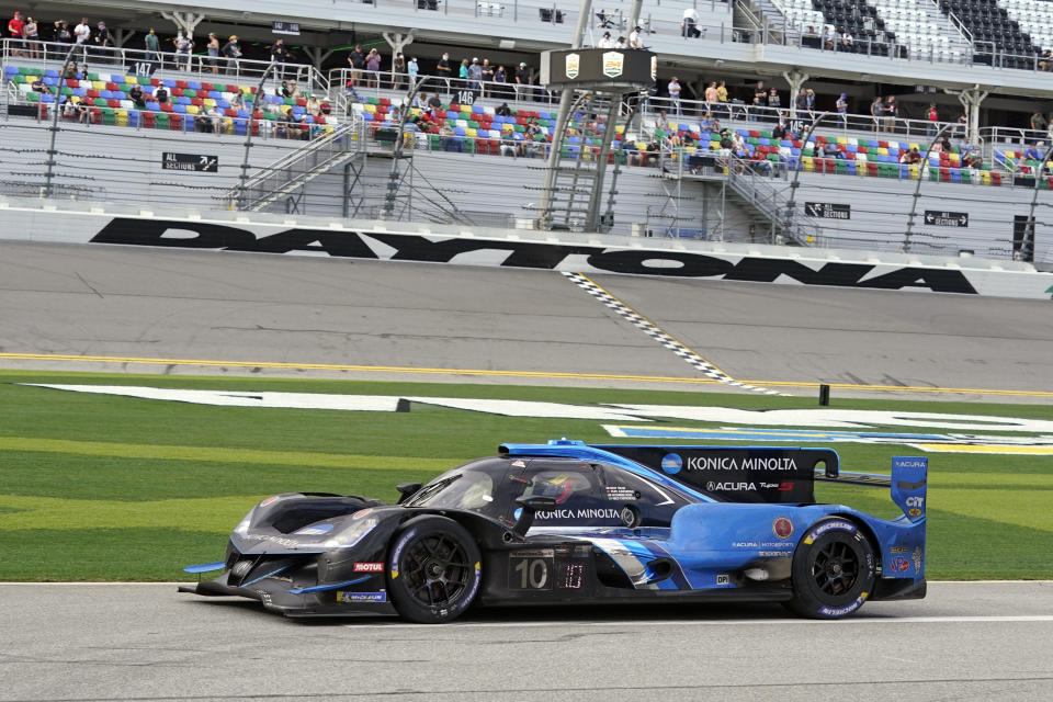 Filipe Albuquerque drives his Acura DPi out pit road to the track after his last pit stop in the Rolex 24 hour auto race at Daytona International Speedway, Sunday, Jan. 31, 2021, in Daytona Beach, Fla. (AP Photo/John Raoux)