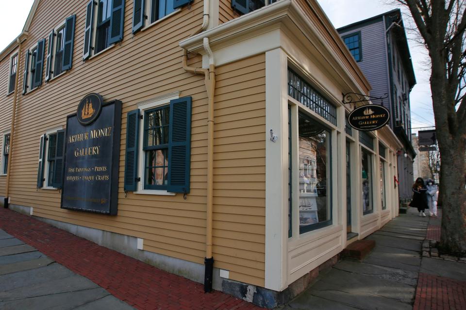 Two women walk down William Street in New Bedford past the Arthur Moniz Gallery which will close after twenty years.