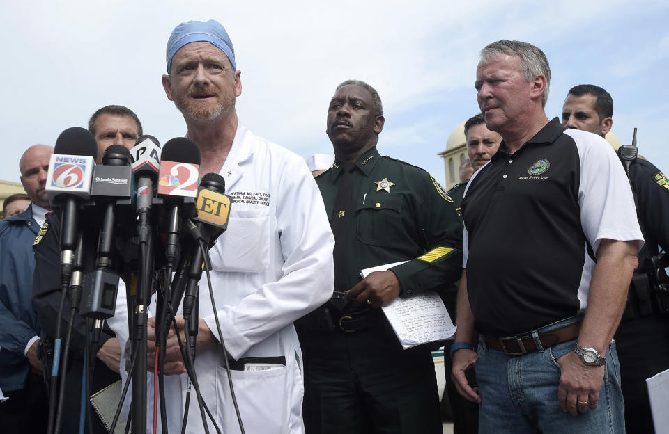 <p>Dr. Michael Cheatham, chief surgeon of the Orlando Health Regional Medical Center hospital, addresses reporters during a news conference after a shooting involving multiple fatalities at a nightclub in Orlando, Fla., Sunday, June 12, 2016. Watching are Orange County Sheriff Jerry Demings, second from right, and Orlando Mayor Buddy Dyer. (AP Photo/Phelan M. Ebenhack) </p>