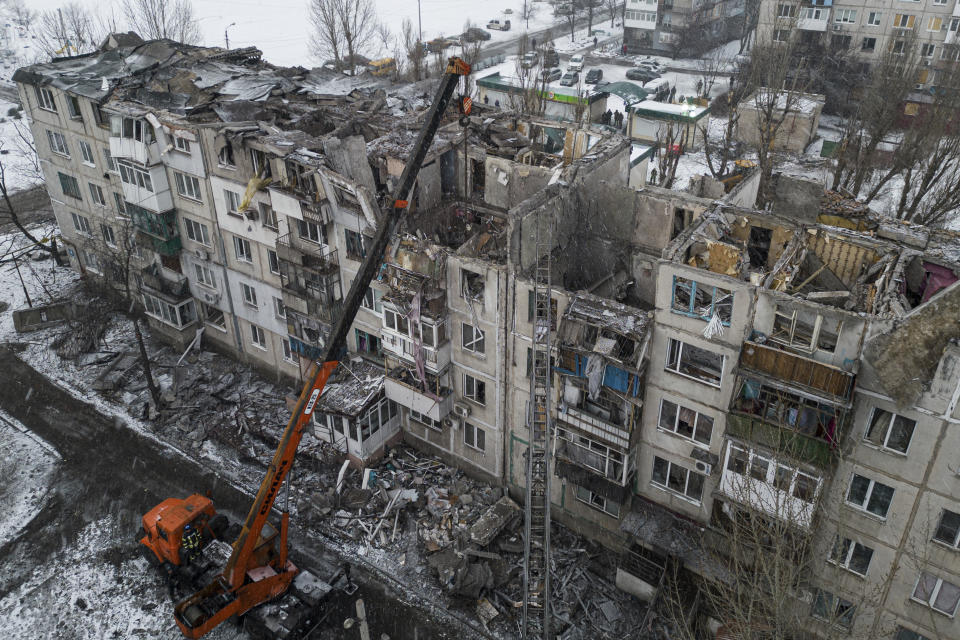 FILE - Rescue workers clear the rubble of a residential building destroyed by a Russian rocket in Pokrovsk, Ukraine, on Feb. 15, 2023. According to local authorities, at least two people were killed and 12 injured. Some experts warn that the war, which already has killed tens of thousands on both sides and reduced entire cities to ruins, could drag on for years. (AP Photo/Evgeniy Maloletka, File)