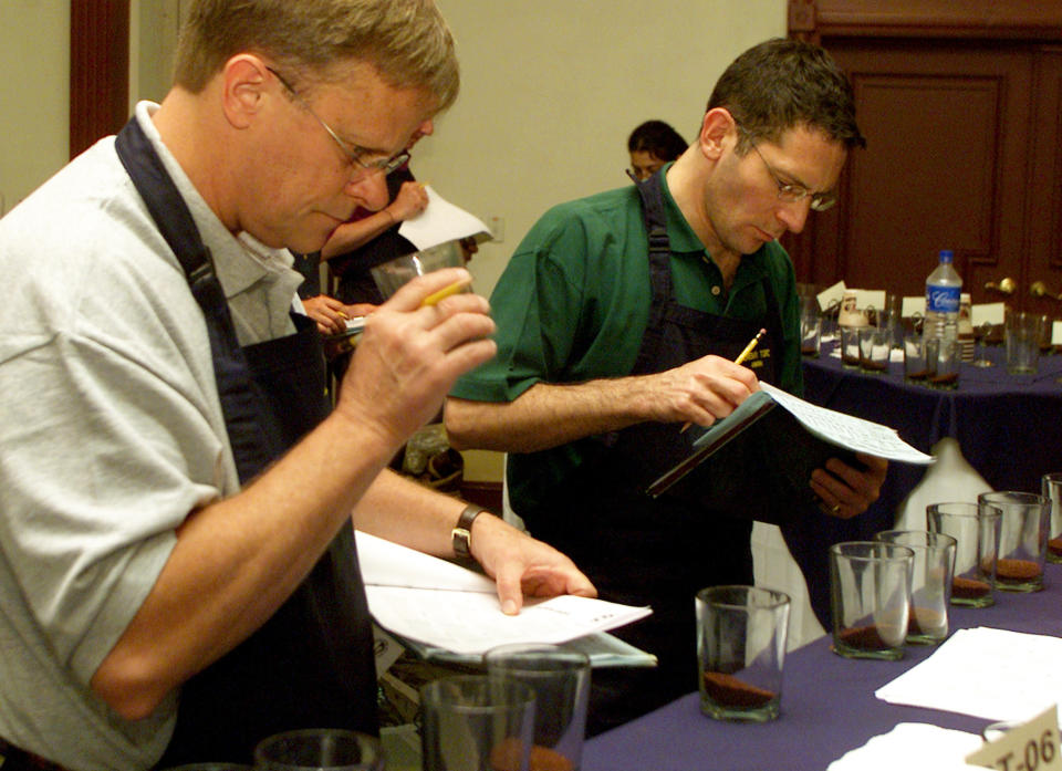 Stave Leach (L), Jeremy Torz (R) international coffee consults
participate in examining the best coffee produced in El Salvado, during
the final round of the Cup of Excellence event in the capital, May 9,
2003.REUTERS/Luis Galdamez

LG