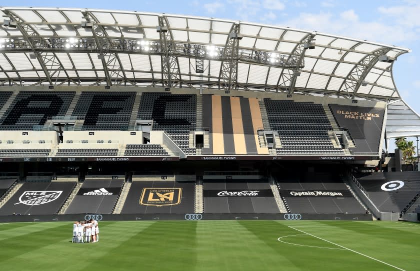 LOS ANGELES, CALIFORNIA AUGUST 22, 2020-Galaxy soccer players gather at an empty stadium before a game against LAFC at Banc of California in Los Angeles Saturday. (Wally Skalij/Los Angeles Times)