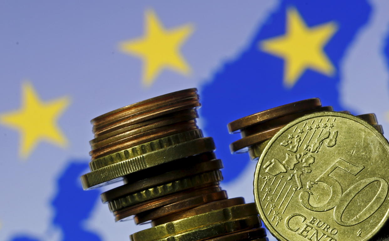 Euro coins are seen in front of displayed flag and map of European Union in this picture illustration taken in Zenica, May 28 2015. The president of the European Central Bank called on euro zone countries to reform their economies, warning that future growth, in the face of entrenched unemployment and low investment, will be modest.  REUTERS/Dado Ruvic