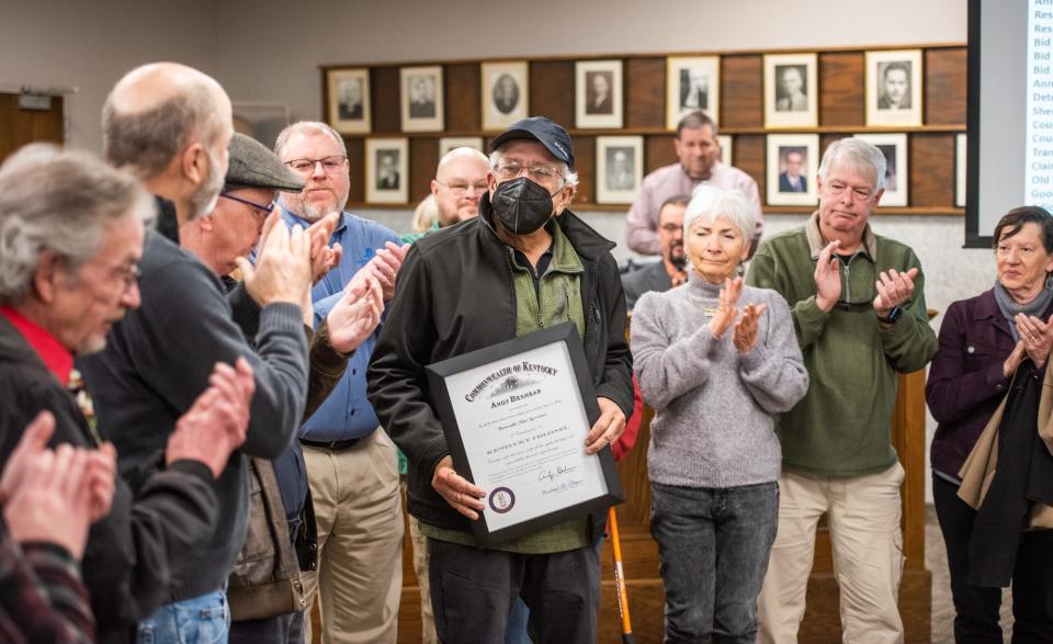 Former Henderson Gleaner and  Evansville Courier & Press photojournalist Mike Lawrence, center, was awarded the commission of Kentucky Colonel Tuesday morning, Dec. 20, 2022. Henderson County Judge Executive Brad Schneider presented the award to Lawrence in recognition of his 40 years  working in journalism in the Tri-State area. The Kentucky Colonel is the highest honor awarded by the Commonwealth of Kentucky.