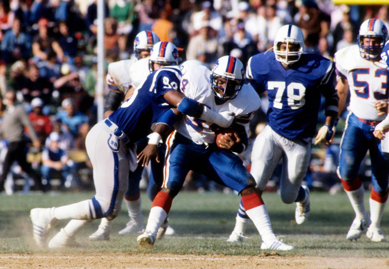 Buffalo Bills running back Booker Moore carries the ball against the Baltimore Colts at Memorial Stadium.
