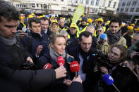 FILE - Marion Marechal, Marine Le Pen's niece and Executive Vice President of French far-right party 'Reconquete', center, speaks with farmers and journalists during a demonstration of French and Belgian farmers outside the European Parliament in Brussels, on Jan. 24, 2024. (AP Photo/Virginia Mayo, File)