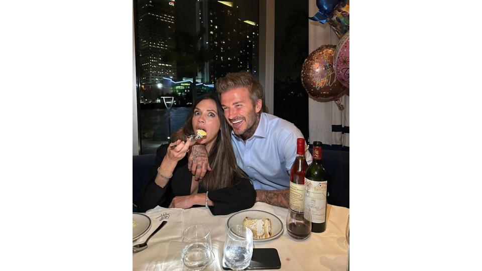 Victoria Beckham eating cake beside her husband David Beckham