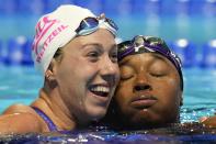 Simone Manuel and Abbey Weitzeil hug after the women's 50 freestyle during wave 2 of the U.S. Olympic Swim Trials on Sunday, June 20, 2021, in Omaha, Neb. (AP Photo/Jeff Roberson)