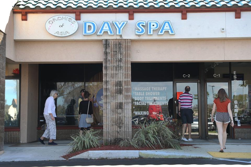 People mill around in front of the Orchids of Asia Day Spa after  New England Patriots owner Robert Kraft being charged with allegedly soliciting for sex on Feb. 22, 2019 in Jupiter, Florida. Mr. Kraft was caught up in a law enforcement operation in South Florida that netted hundreds of johns over the past two weeks.