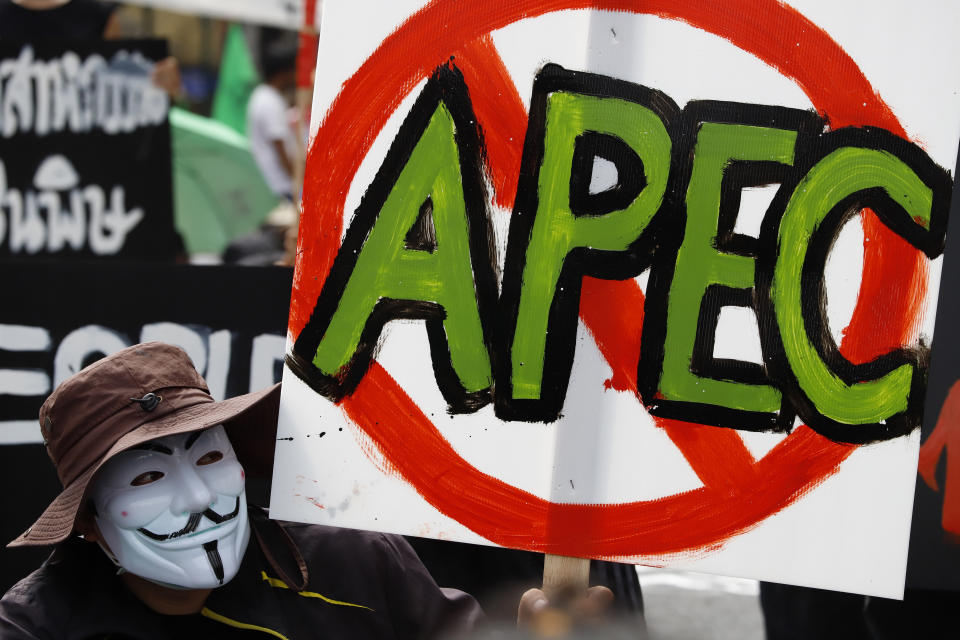 A demonstrator holds a sign during a protest against the Asia-Pacific Economic Cooperation APEC summit venue, Friday, Nov. 18, 2022, in Bangkok, Thailand. (AP Photo/Sarot Meksophawannakul)