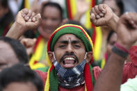 A man shouts anti-government slogans during a protest against farm bills in Bengaluru, India, Monday, Sept. 28, 2020. Indian lawmakers earlier this month approved a pair of controversial agriculture bills that the government says will boost growth in the farming sector through private investments. (AP Photo/Aijaz Rahi)