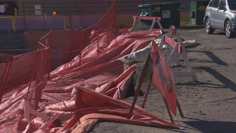 Theatre company parking lot sinks into construction site next door