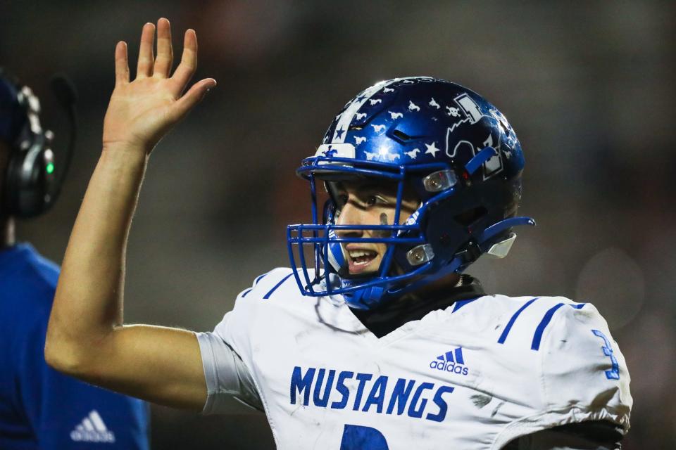 Ingleside's Aidan Jakobsohn (3) high fives a teammate after a Mustangs touchdown in a high school football game against Orange Grove at Bulldog Stadium in Orange Grove, Texas on Friday, Oct. 28, 2022.