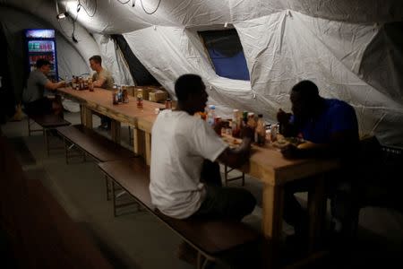 Members of U.S. Army have their dinner at a military base southwest of Mosul, Iraq April 28, 2017. REUTERS/Suhaib Salem