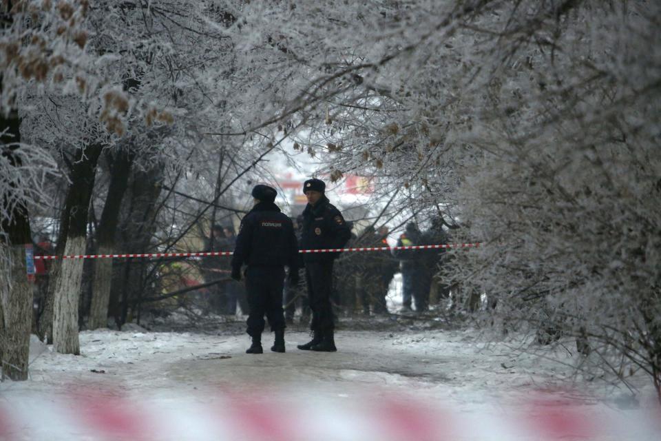 Police stand guard at the site of a blast on a trolleybus in Volgograd