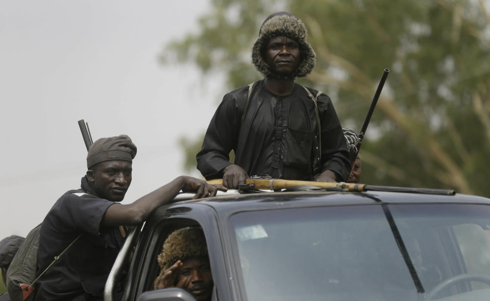 Vigilantes and local hunters armed with locally made guns patrol on the street near the Independent National Electoral Commission office in Yola, Nigeria, Monday Feb. 25, 2019. Official results of Nigeria's presidential election are expected as early as Monday in what is being seen as a close race between Incumbent President Muhammadu Buhari and opposition candidate Atiku Abubakar (AP Photo/Sunday Alamba)