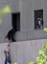 <p>A man hands a child to a security guard from Iran’s parliament building after an assault of several attackers, in Tehran, Iran, Wednesday, June 7, 2017. (Photo: Fars News Agency, Omid Vahabzadeh via AP) </p>