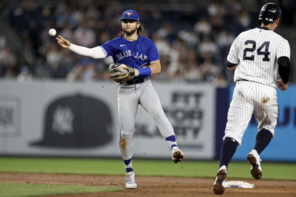 Toronto Blue Jays shortstop Bo Bichette throws to first after forcing out New York Yankees' Gary Sanchez (24) on a double play hit into by Gio Urshela during the fifth inning of a baseball game Thursday, Sept. 9, 2021, in New York. (AP Photo/Adam Hunger)