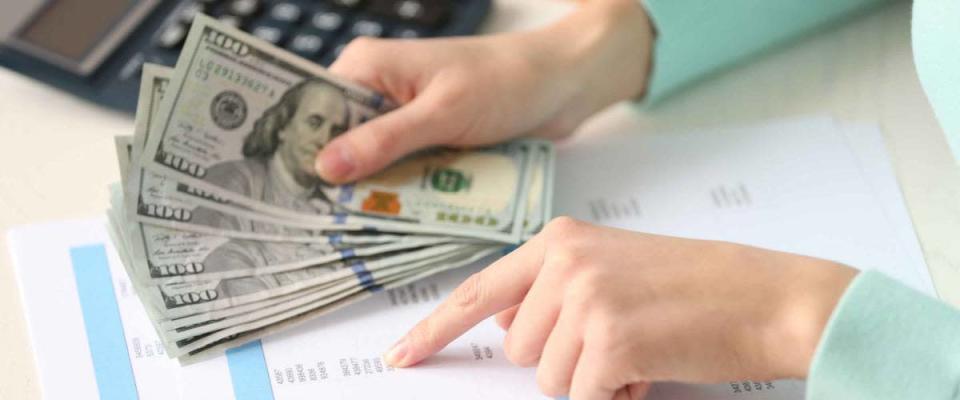 Woman counting money at the table