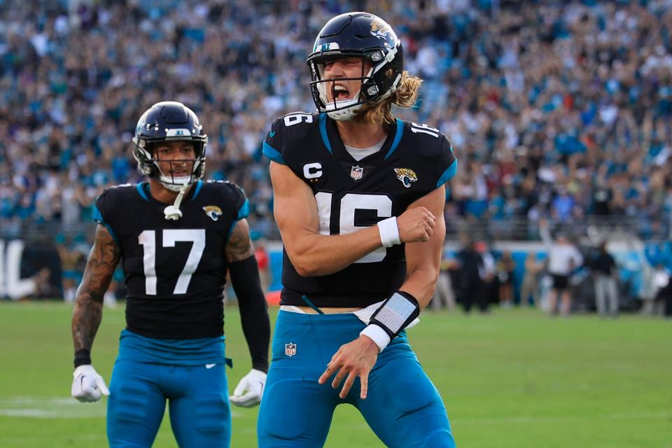 Jacksonville Jaguars quarterback Trevor Lawrence (16) reacts to his touchdown  pass as teammate tight end Evan Engram (17) looks on during the fourth quarter of a regular season NFL football matchup Sunday, Nov. 27, 2022 at TIAA Bank Field in Jacksonville. The Jaguars edged the Ravens 28-27. 