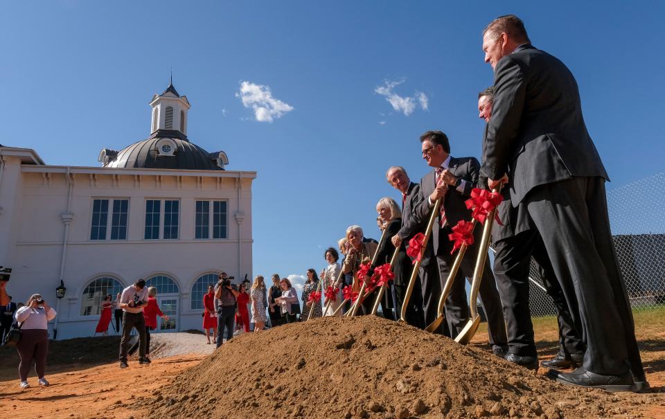Dignitaries turn dirt during the groundbreaking for the Smith Family Center For The Performing Arts at the University of Alabama Friday, Oct. 20, 2023.