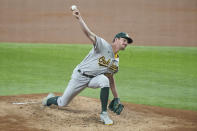Oakland Athletics starting pitcher Chris Bassitt throws a pitch in the first inning against the Texas Rangers in the first inning in a baseball game Thursday, June 24, 2021, in Arlington, Texas. (AP Photo/Louis DeLuca)